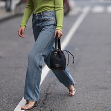 Woman crossing the street in New York wearing casual jeans, an outfit fitting for an unpretentious perfume