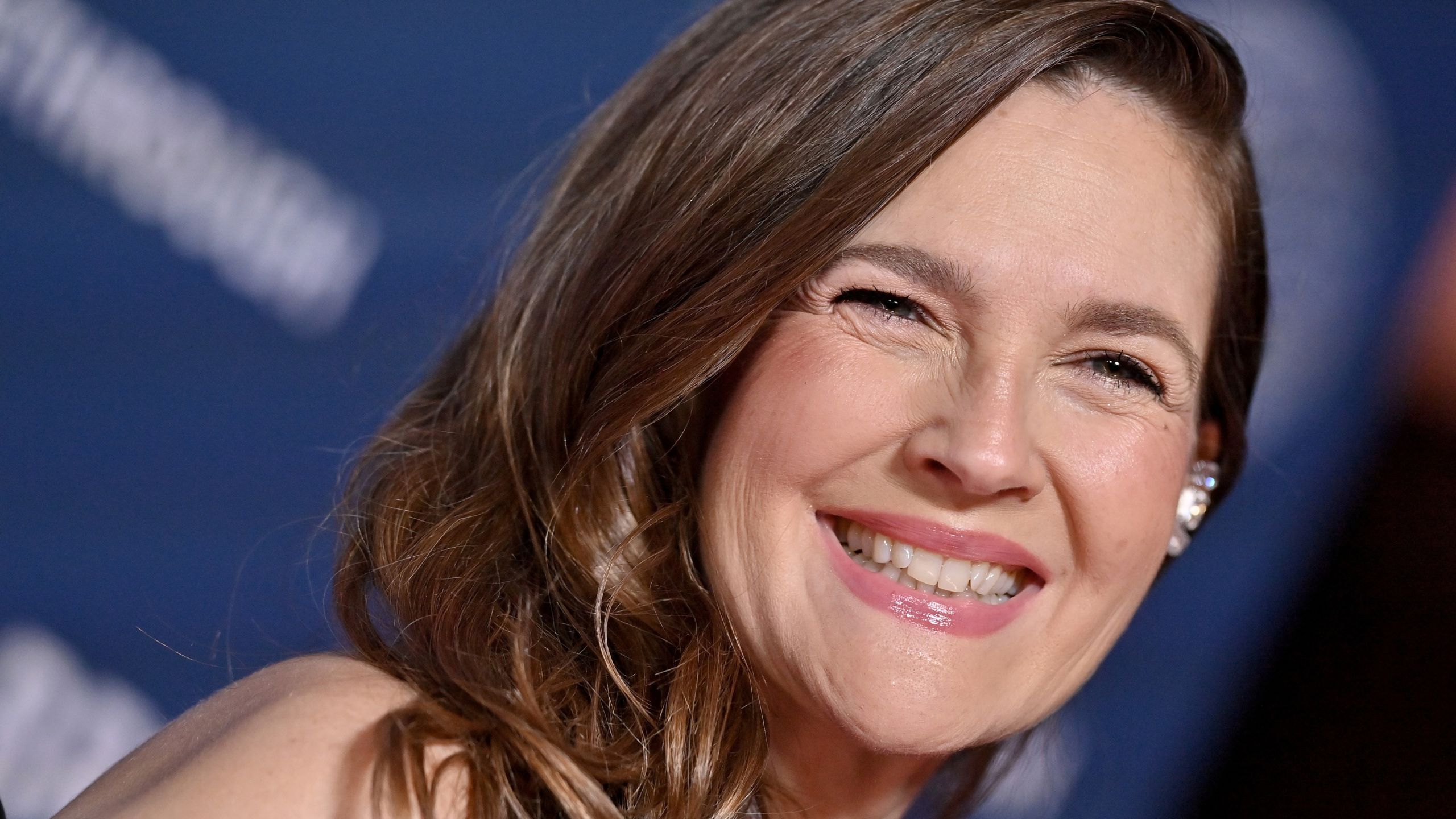 drew barrymore on a blue background