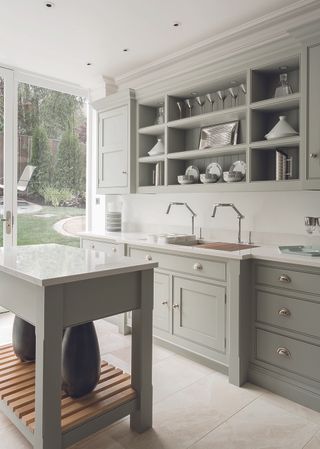 Kitchen with gray cabinetry and stone floor