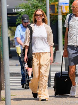 Jennifer Lawrence walks down the street wearing a white T-shirt and drawstring pants from Leset