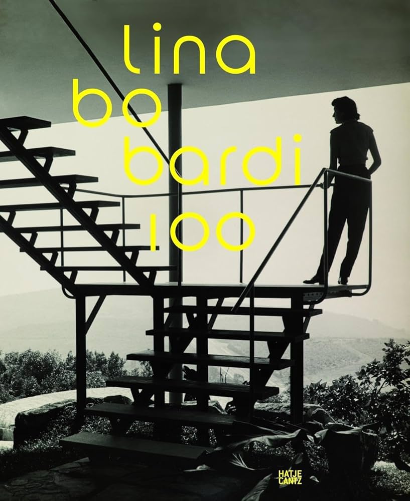 A book with a black and white cover depicting a woman on a modernist staircase topped with a title that reads "lina bo bardi 100" in yellow.