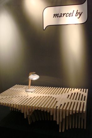 A wood coffee table with a lamp on top.