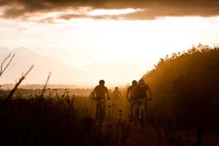 Riders in the sunrise during stage six of the 2010 Absa Cape Epic Mountain Bike stage race between Worcester and Oak Valley in the Western Cape, South Africa on the 26 March 2010