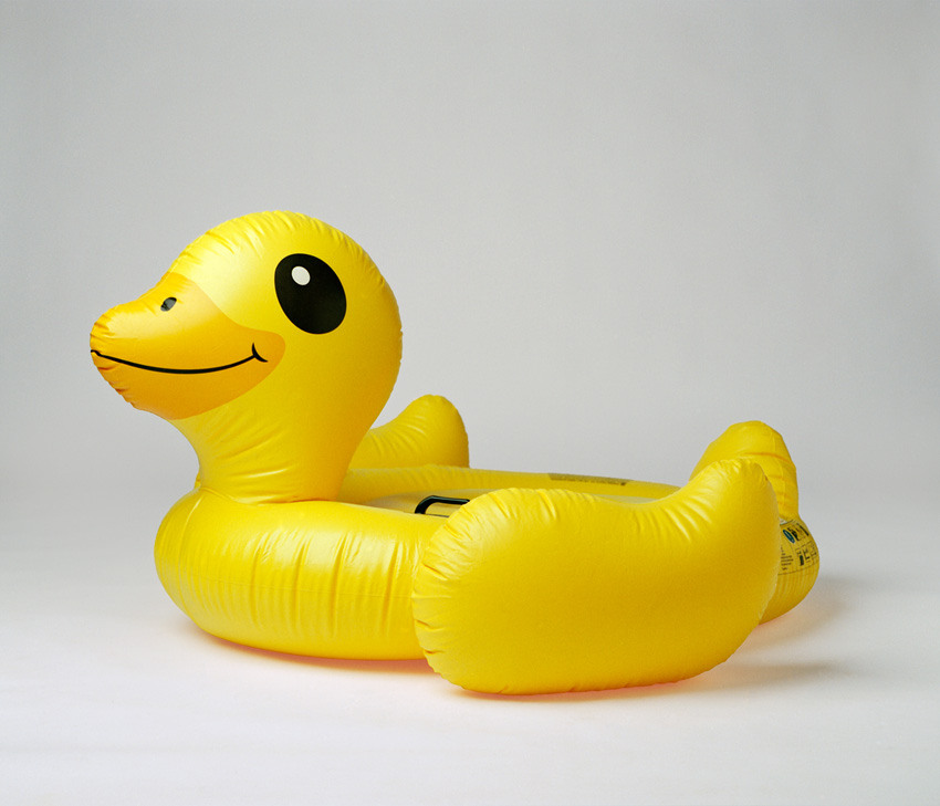 A inflatable yellow rubber duck in a studio