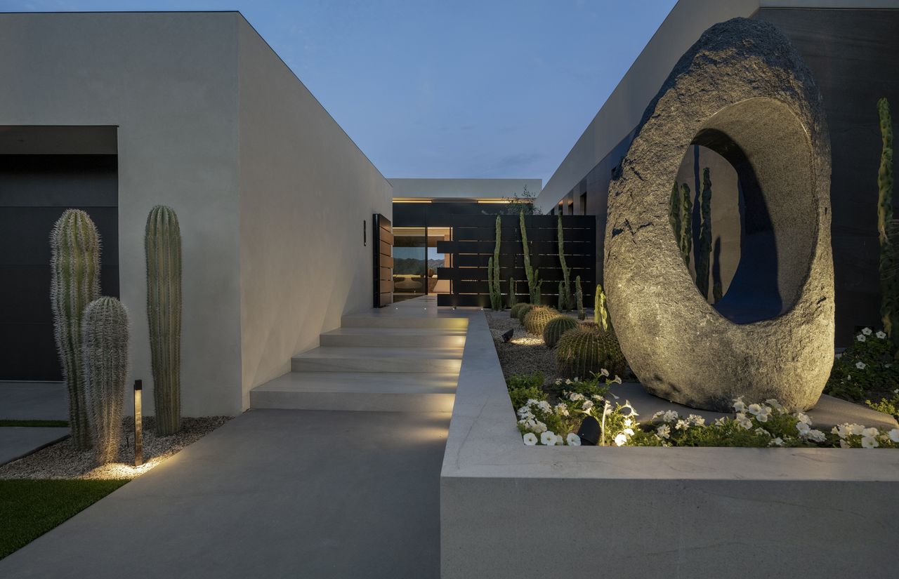 A front yard pathway lit with recessed lighting