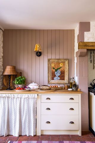 a country kitchen with a textile lamp shade wall light