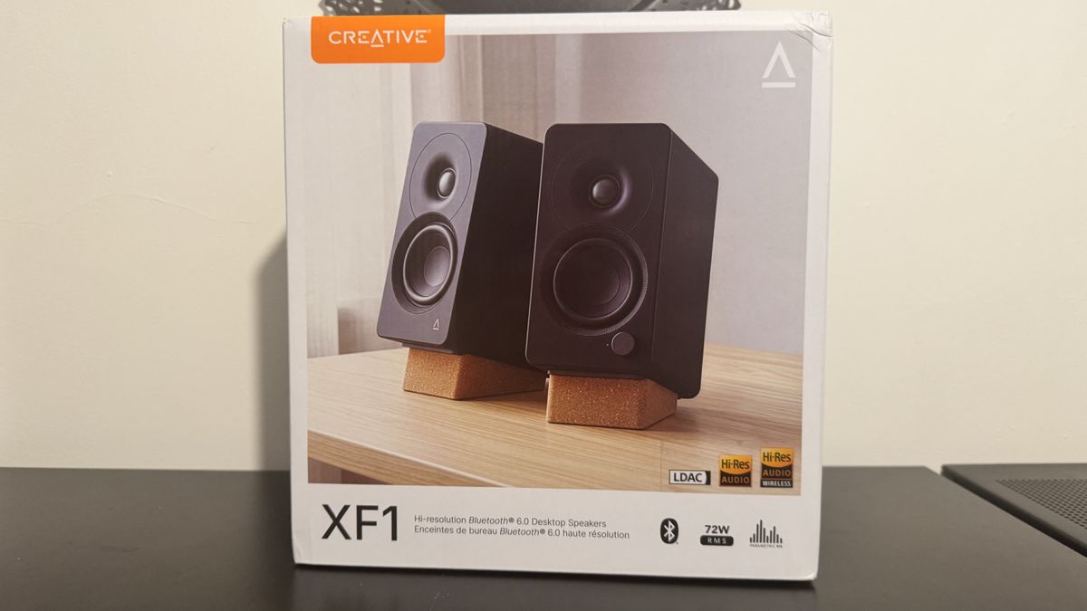 Creative XF1 speakers on a black desk
