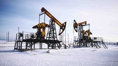 Oil derricks on a snowy Russian field