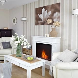 white living room with fireplace and floral art and white coffee table