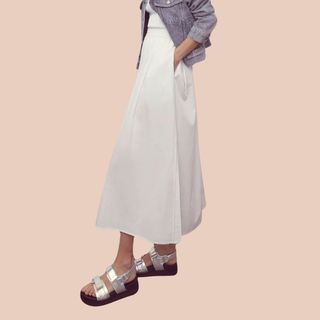 flat lay image of woman in white skirt 