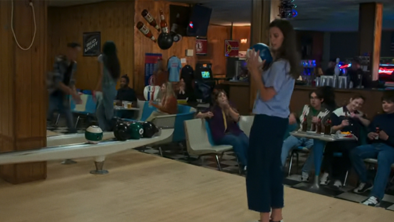A woman holding a bowling ball at Saratoga Lanes in Soul on Fire