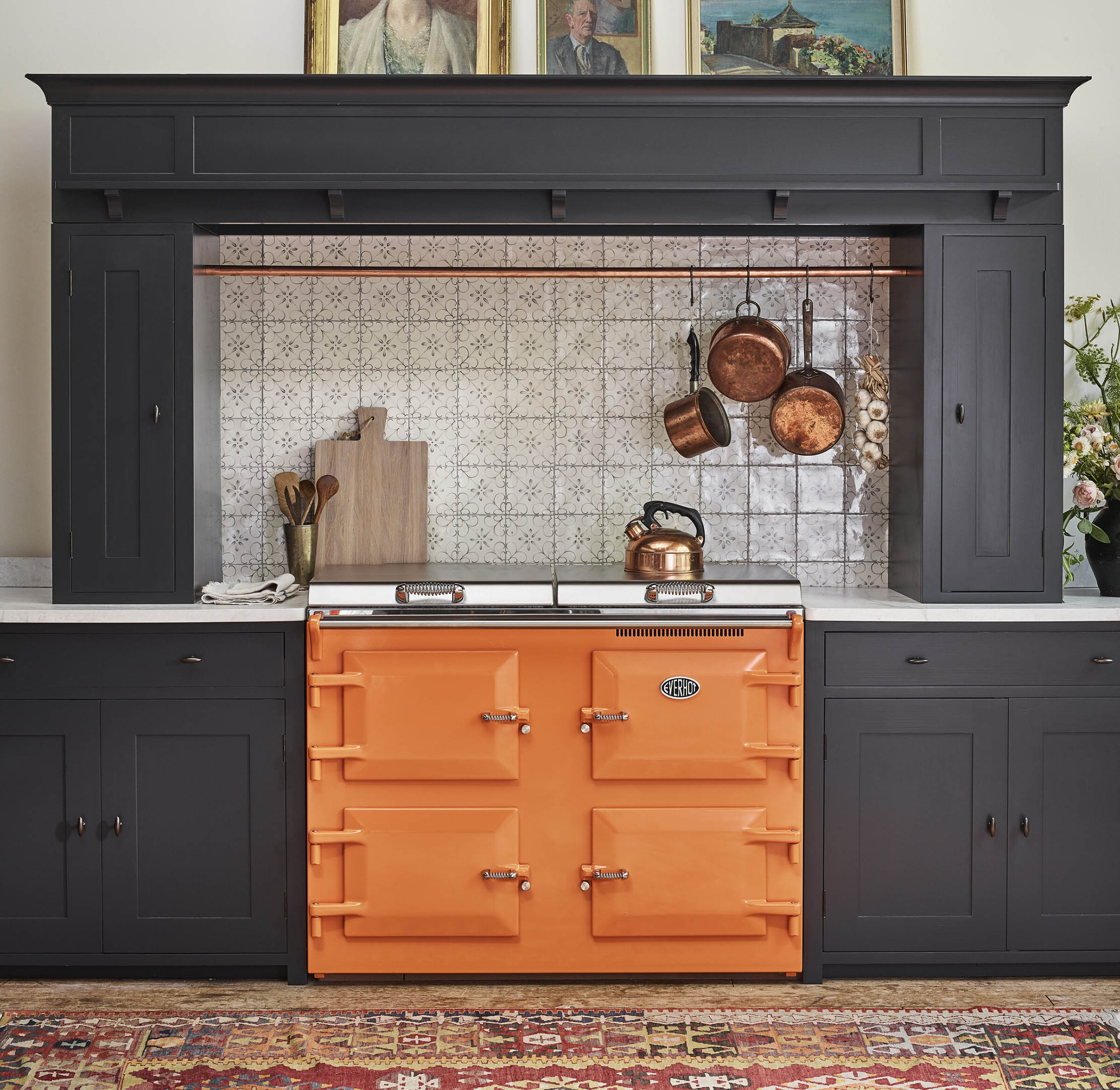 A Neptune Suffolk kitchen with an Everhot in tangerine makes a striking mix.