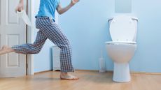Man in night clothes running to toilet.
