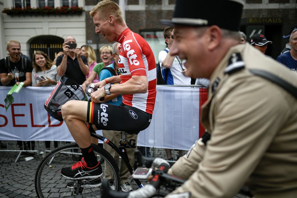 A man wearing an old French gendarme uniform performing rides with Germany's Marcel Sieberg (L) during the parade of the team presentation ceremony in Dusseldorf