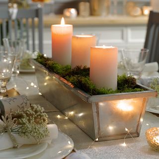 dinner table with candles and lighting cords