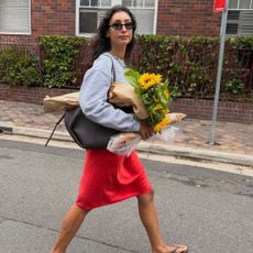 BÁRBARA SANTIAGO wears a Crew Neck + Red Skirt + Flip Flops
