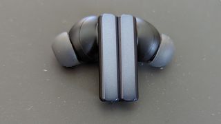 The EarFun Air Pro SV wireless earbuds resting on a gray pillow