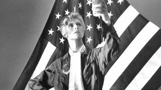 David Bowie in front of an American flag in 1975
