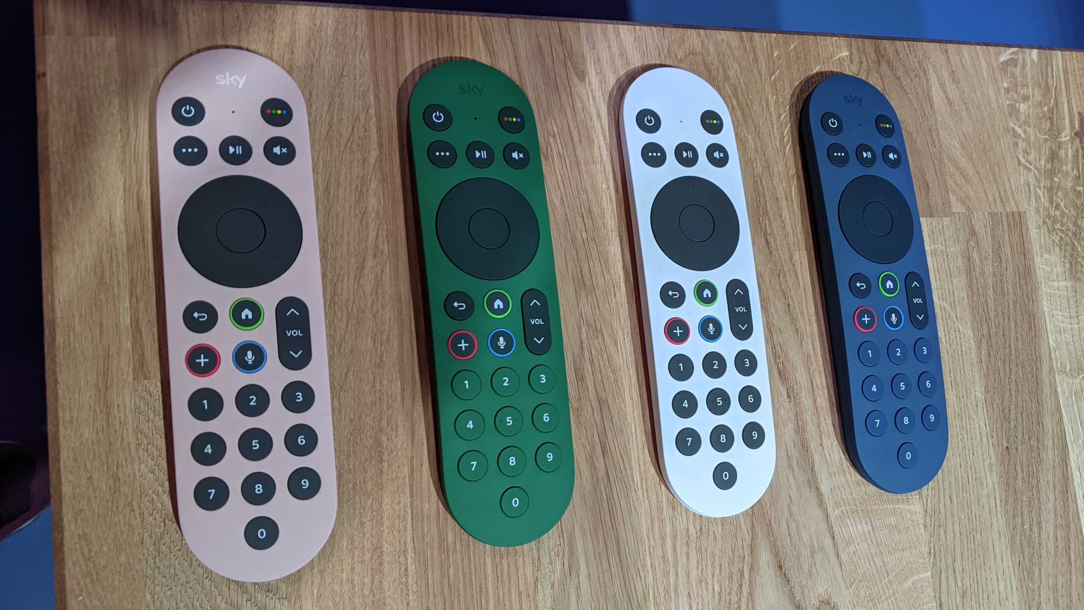 sky glass remotes along table in four different colors