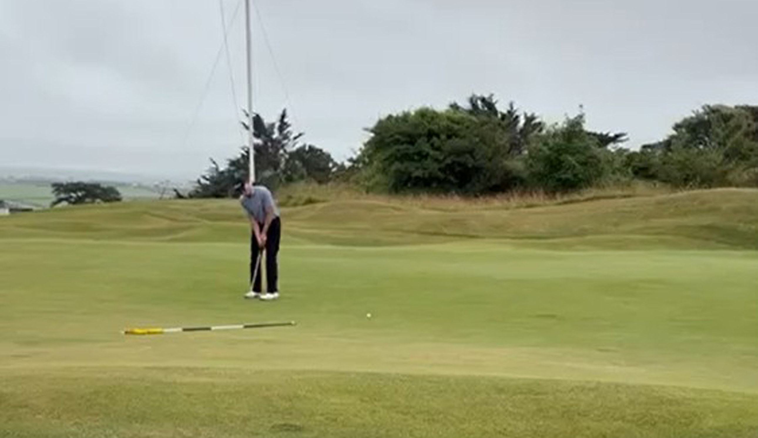 A golfer hits the winning putt