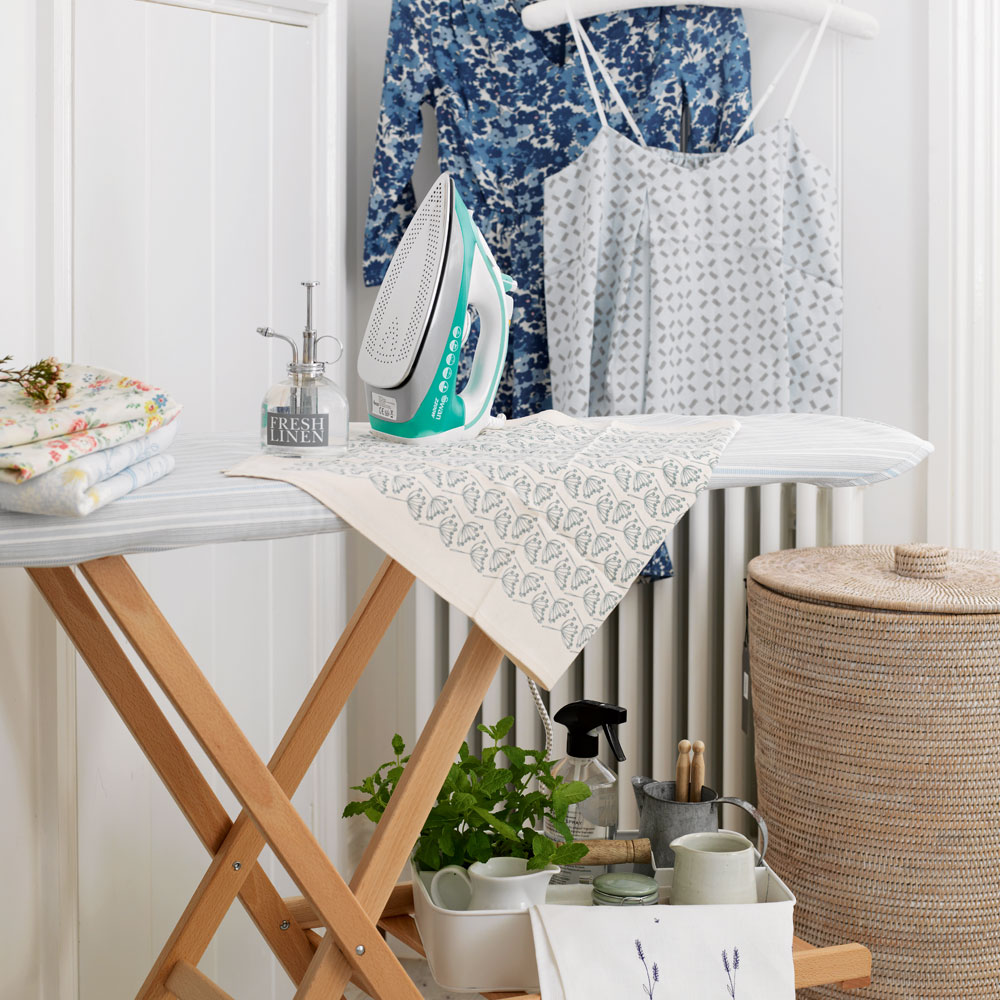room with white wall and iron on wooden table