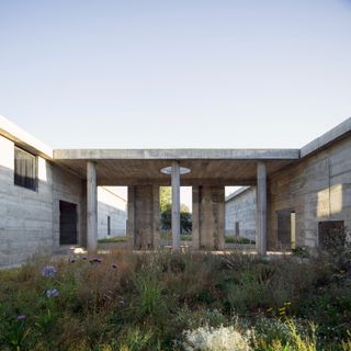 concrete courtyard with colonnade at Luna House by Pezo von Ellrichshausen in Chile