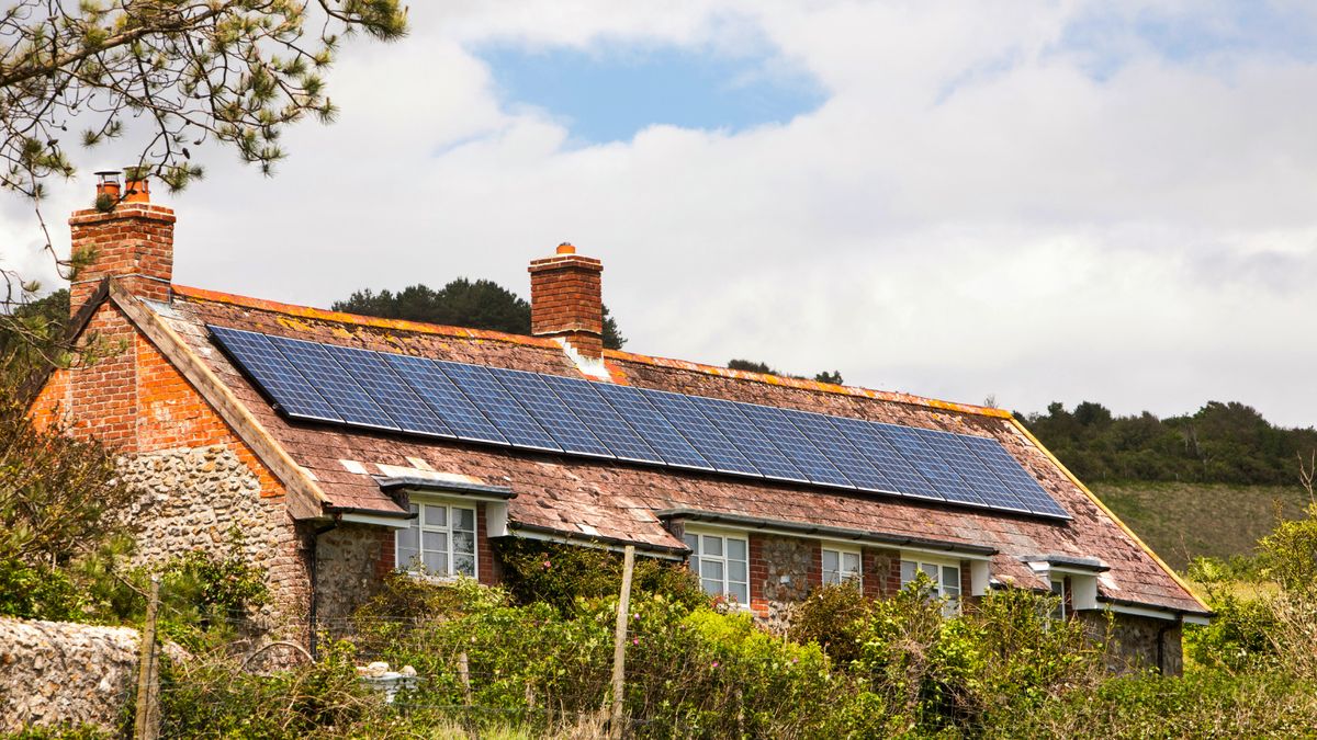 solar panels on large stone cottage in countryside location