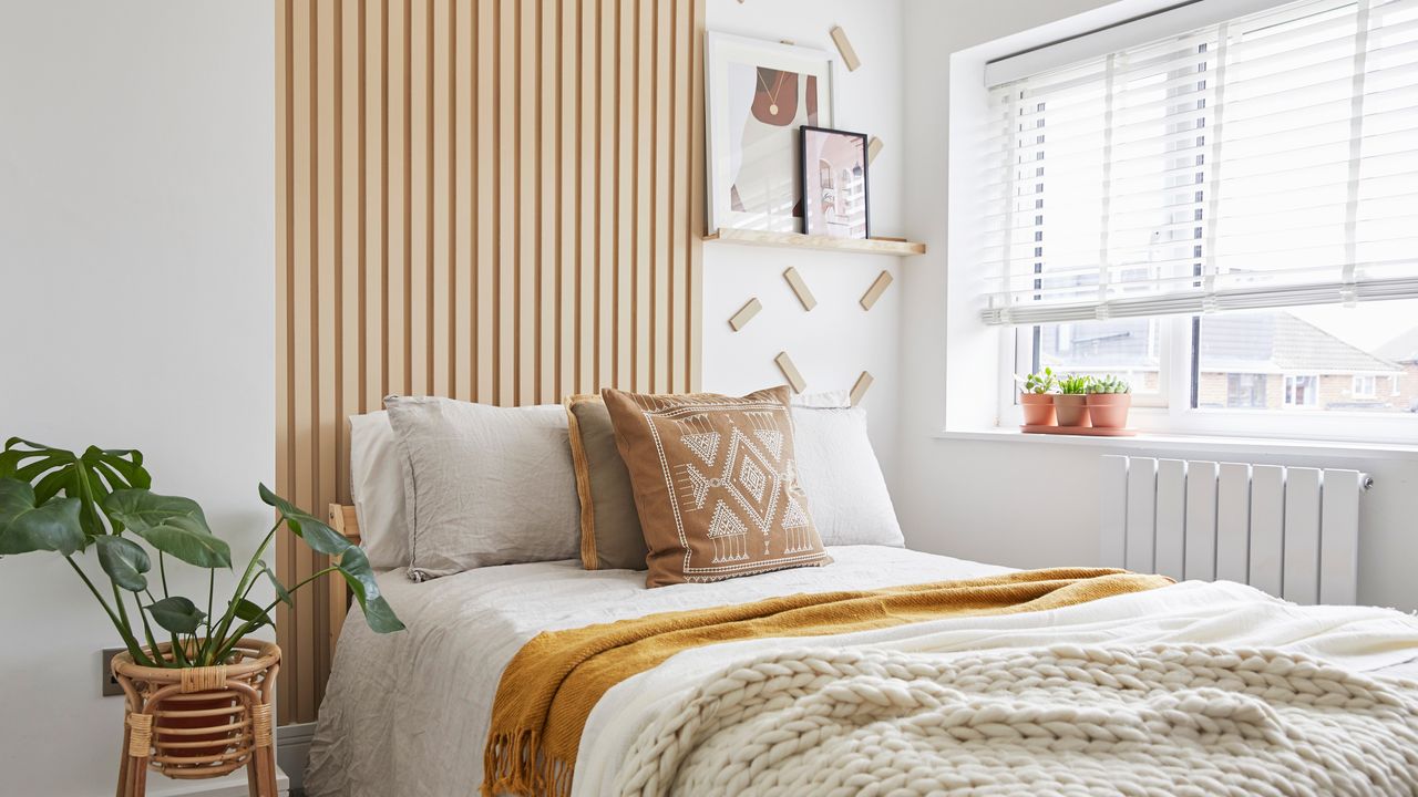 White bed in white bedroom with wooden panelling