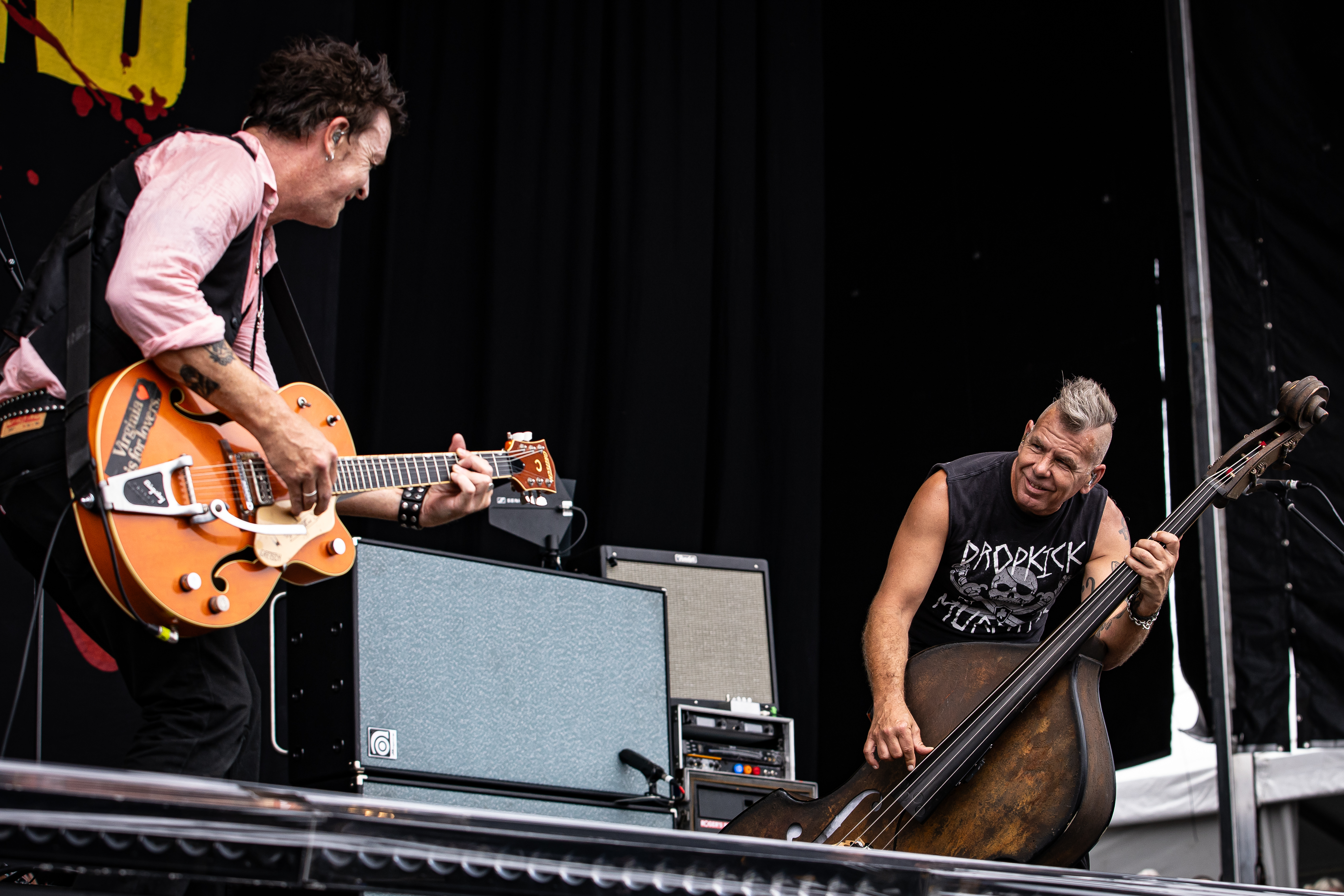 Guitarist Chris Cheney and double bassist Scott Owen perform live on stage
