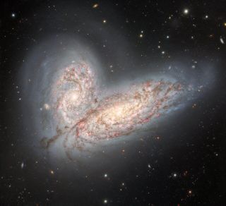 two colliding galaxies are merging to look like a pair of butterfly wings.