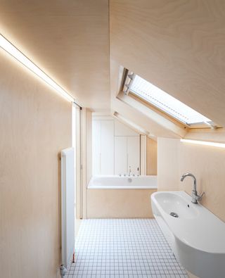 A bathroom with LED strip along a wall