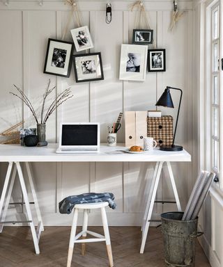 study room with photoframe on white wall and wooden flooring