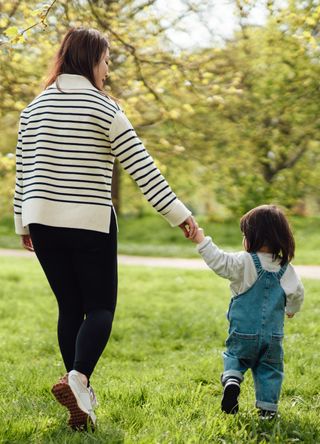 Woman exploring a park with a child