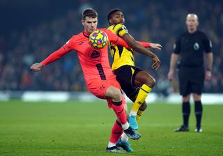 Norwich City’s Jacob Sorensen (left) and Watford’s Emmanuel Dennis battle for the ball during the Premier League match at Vicarage Road, Watford. Picture date: Friday January 21, 2022
