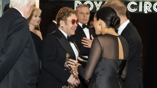 Britain's Prince Harry, Duke of Sussex (R) and Britain's Meghan, Duchess of Sussex (2nd R) chat with British singer-songwriter Elton John (C) as they arrive to attend the European premiere of the film The Lion King in London on July 14, 2019.