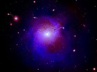 A composite image of X-ray and optical observations of the Perseus galaxy cluster. This image contains X-ray data from the Chandra X-ray Observatory (blue) of the Perseus galaxy cluster. The observations have been combined with optical data from the Hubble space telescope (pink) and radio-emission data from the Very Large Array (red) in New Mexico. If these findings are confirmed with future observations, it would signal a major step forward in comprehending the nature of dark matter, researchers said in a statement.