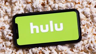 Hulu logo on iPhone on top of popcorn 