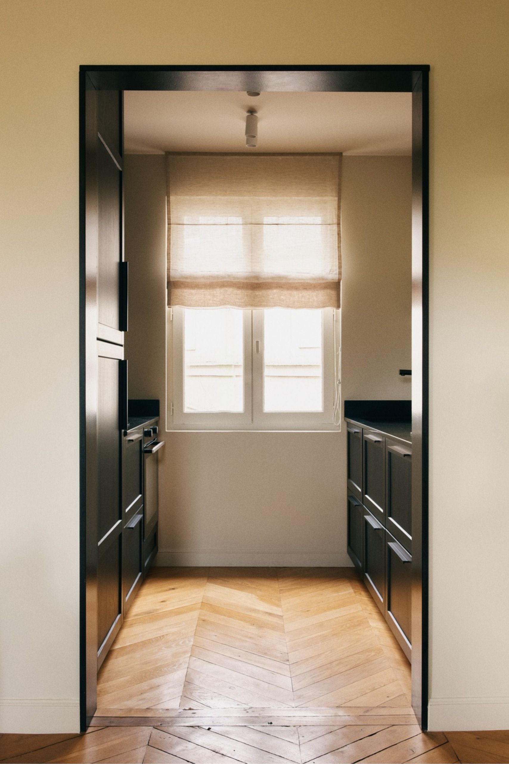 Small kitchen design with black door frame and black cabinets