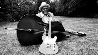 Willie Dixon with his upright bass and a Fender guitar in the backyard of Muddy Waters' house in Westmont, Illinois on June 21, 1981