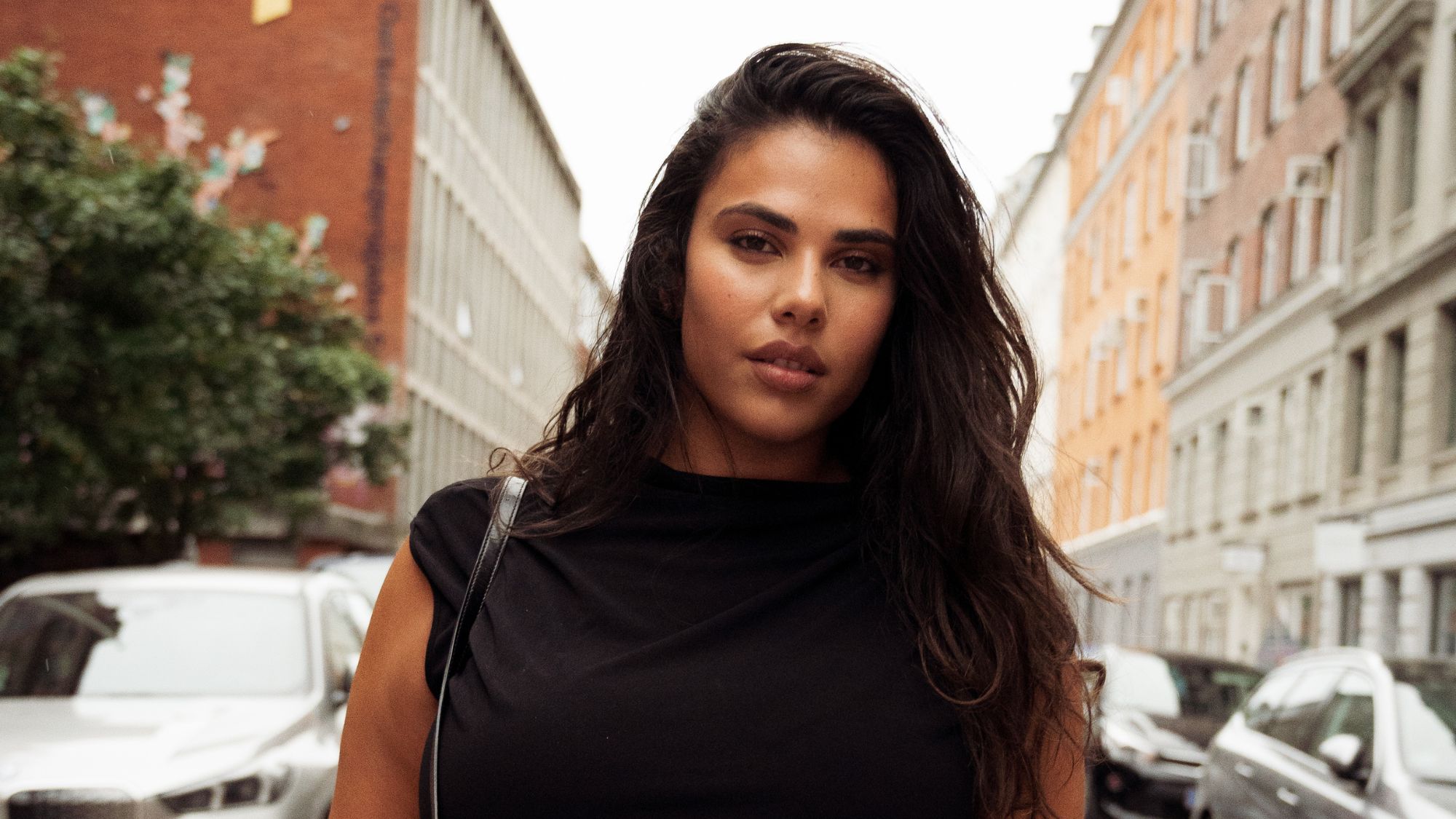 A close up of a woman with beautiful glowy, clear and even skin