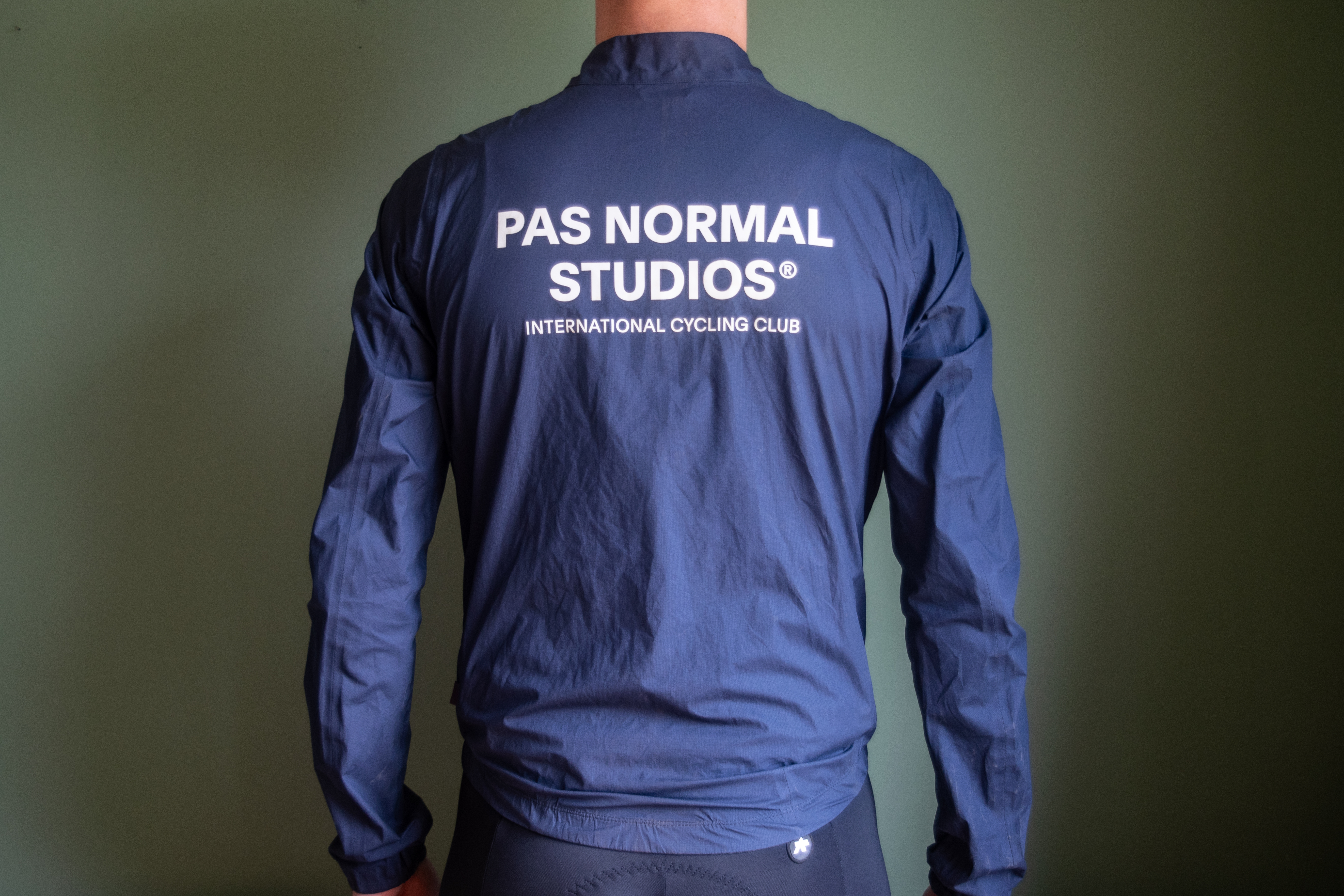 A man wearing a blue Pas Normal waterproof