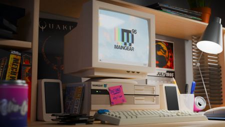 Maingear retro95 gaming PC on desk with speakers at side and keyboard in front.