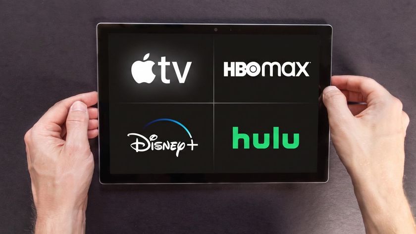 (Clockwise from top right) Apple TV, HBO Max, Hulu and Disney Plus logos on a tablet