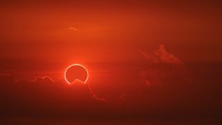 How to photograph a solar eclipse: image shows eclipse in red sky