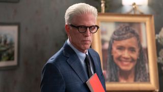 Ted Danson holding a red book to his chest in Man on the Inside.