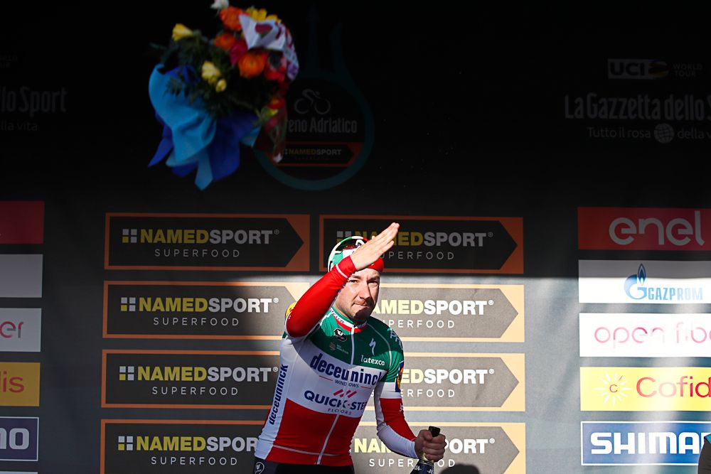 Elia Viviani tosses his bouquet from the podium after winning stage 3 at Tirreno-Adriatico