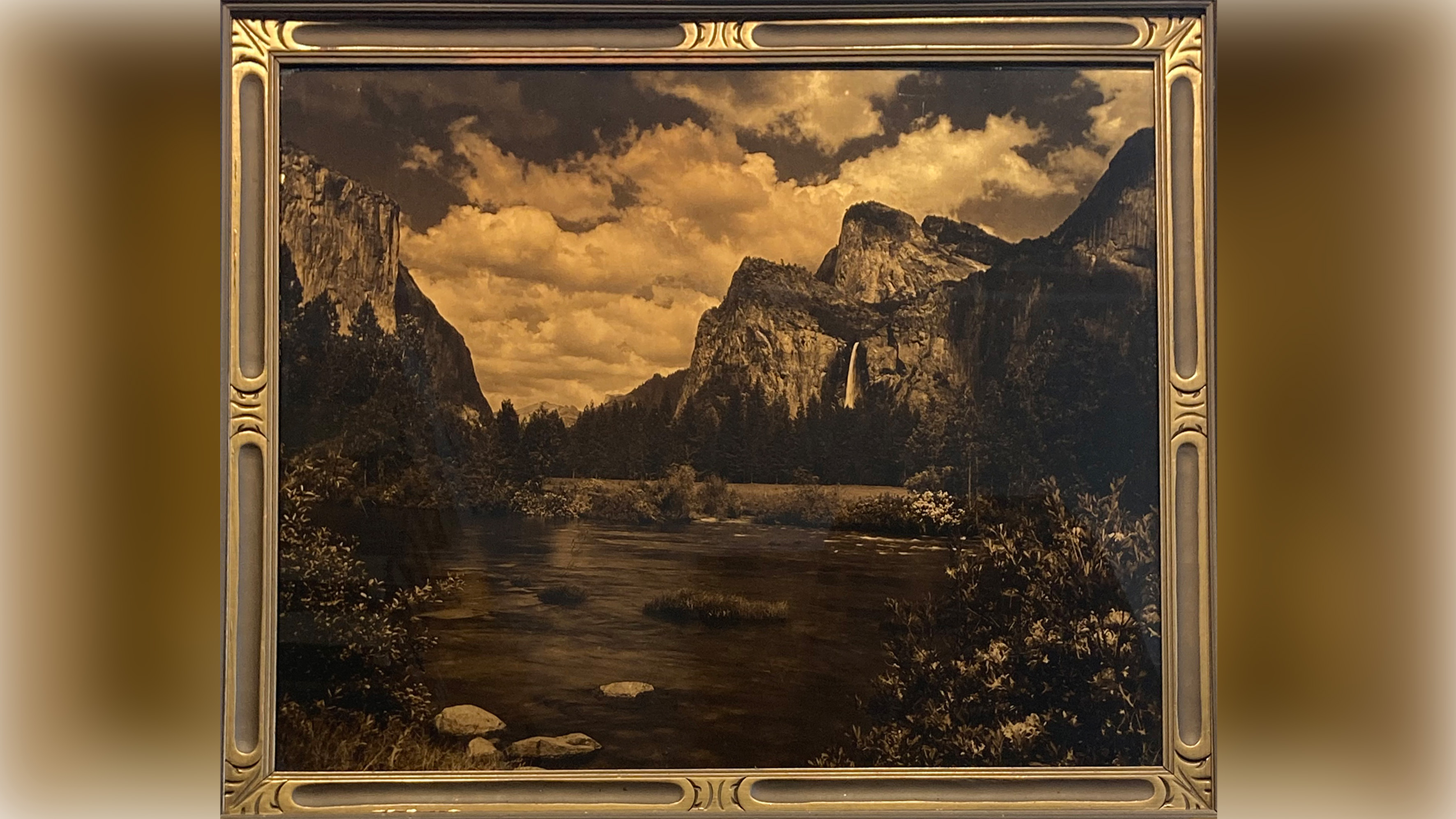 A landscape where a river leads towards a waterfall falling from a cliff face.