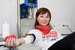A volunteer gives blood.