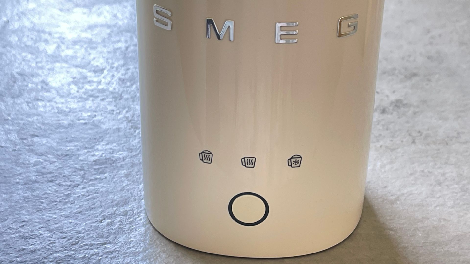 Smeg mini milk frother controls on a cream model