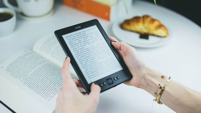 An Amazon Kindle ereader being used to read a book